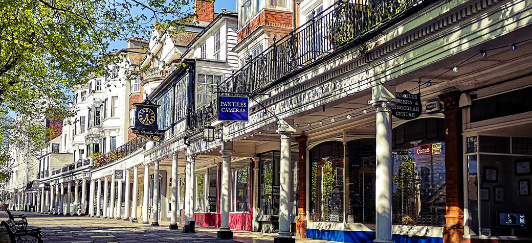The Pantiles in Tunbridge Wells showing historic white colonnades and traditional English architecture.