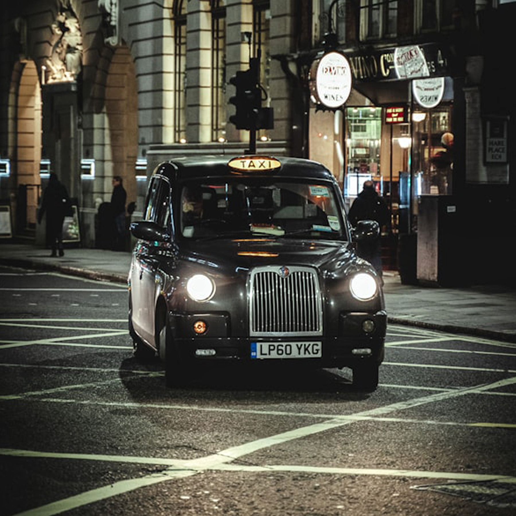 A professional taxi on a city street representing specialized testing for taxi compliance and fleet operators.