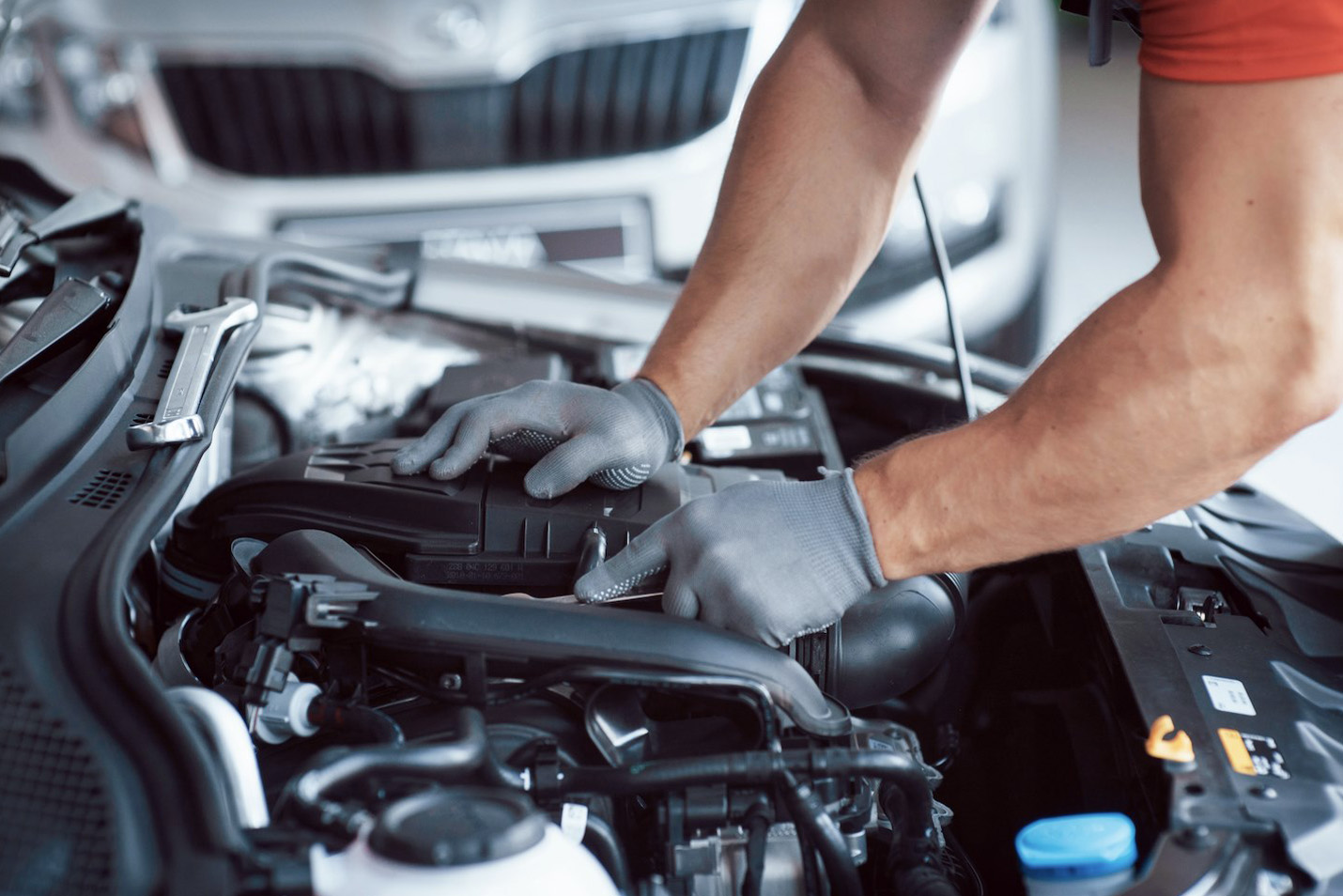 Mechanic performing a fair and strict MOT inspection on a car engine