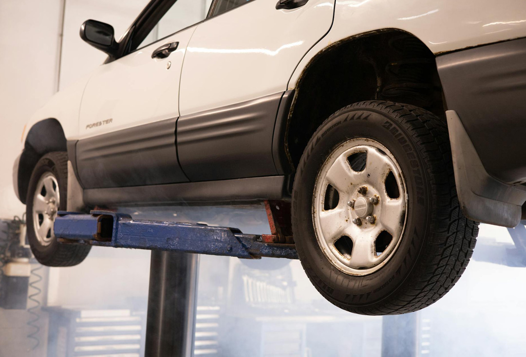 Professional vehicle lifting for annual service and loyalty discount checks