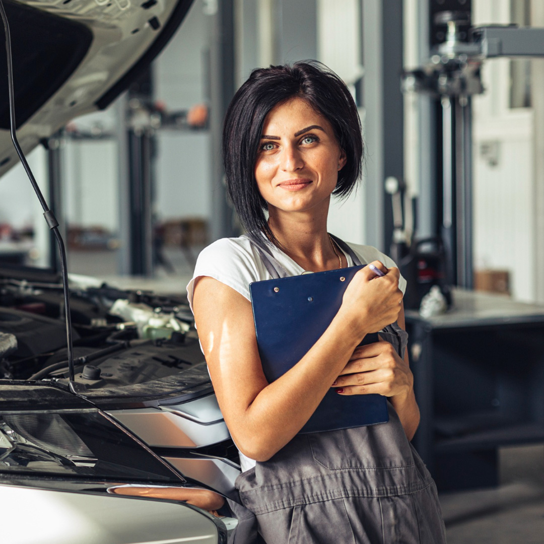 Sarah, the Front of House manager, holding a clipboard in the service centre office.
